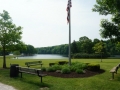 Flag and Benches by Lake at Hudson Springs Park