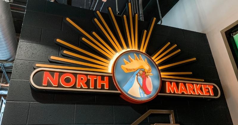 North Market Sign on a black wall with their bright rooster logo