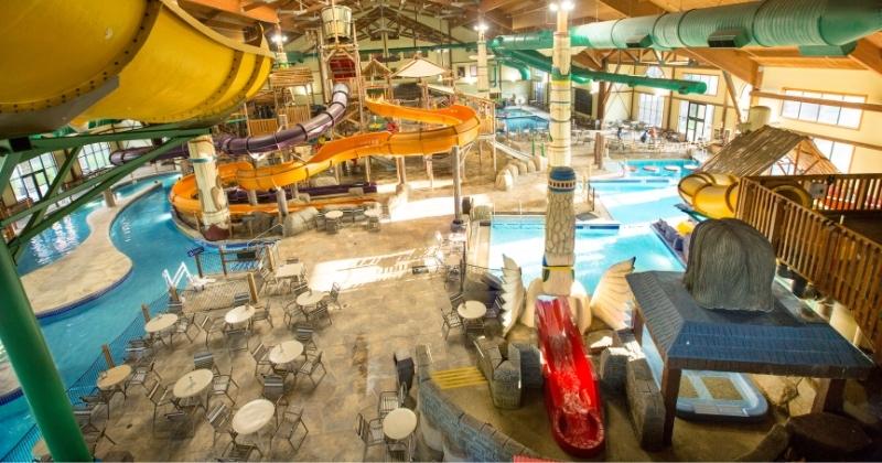 Indoor waterpark with slides lazy river and dining tables